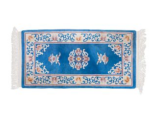 A Chinese Wool and Silk Blue Rug
4 feet 1 inch x 2 feet 1 1/2 inches.