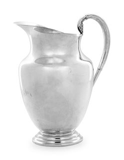 An American Silver Pitcher
Rogers, 20th Century
with stepped foot.