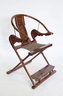 A Hardwood Horseshoe-Back Folding Chair.