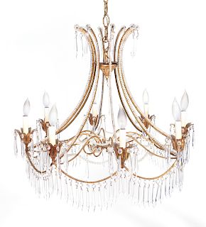 A Regency Style Gilt Metal and Crystal Eight-Light Chandelier
20TH CENTURY
hung with faceted teardrop prisms, with beaded scrolled arms.
Height 26 x d