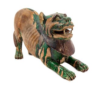 A Chinese Green and Straw Glazed Pottery Figure of a Fu Lion
Length: 18 1/2 in., 47 cm. 