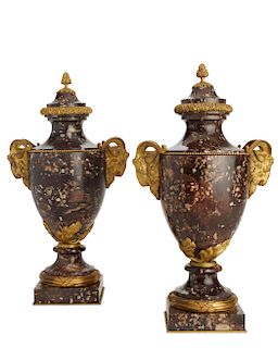 A pair of Louis XVI style marble urns
