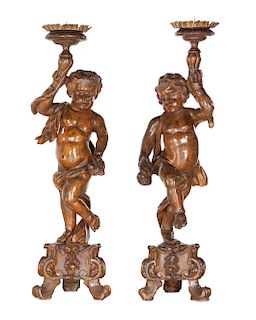 Pair  Italian Baroque walnut putti form prickets