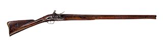 AN EARLY 18TH CENTURY BRITISH FLINTLOCK MUSKET 

A heavy and early 18th century flintlock musket, 56 ½ in. L overall, with a round, ...