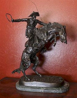 An American Bronze Figural Group, After Frederic Remington (1861-1909) Height overall 24 inches.