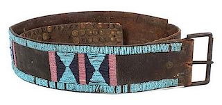 A Crow Hide and Beaded Belt Length overall 61 3/4 inches.