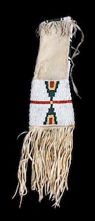 A Cheyenne Beaded and Hide Pipe Bag Length 14 inches; length of fringe 8 inches.