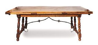 A Spanish Style Extension Table, Joseph F. Milbeck Height 30 1/2 x length 84 1/4 x 39 7/8 inches (closed).