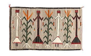 A Navajo Yei Rug First: 67 x 40 inches.