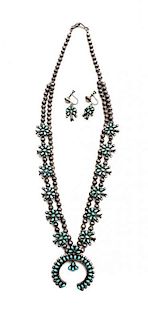 A Zuni Miniature Petit Point Silver and Turquoise Squash Blossom Necklace Length of necklace 20 inches, naja height 1 1/2 x widt