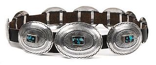 A Southwestern Silver and Turquoise Concha Belt Length of belt 40 inches, height of buckle 3 x width 4 inches.