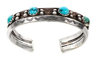 An Early Navajo Silver and Turquoise Bracelet Length 5 7/8 x opening 1 1/8 x width 5/8 inches.