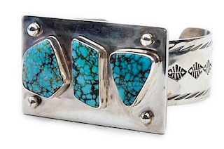 A Silver and Turquoise Tooled Bracelet, Edison Begay Length 6 1/4 x opening 1 1/4 x width 1 1/2 inches.