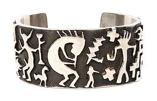 A Yaqui/Spanish Silver Pictograph Cuff Bracelet, Danny Romero Length 5 5/8 x opening 1 1/8 x width 1 1/8 inches.