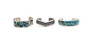 Three Southwestern Silver Bracelets Length of first 5 7/8 x opening 1 1/4 x width 3/4 inches.