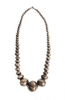 A Navajo Graduated Silver Bead Necklace Length 25 inches; diameter of largest bead 1 1/2 inches.