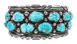 A Navajo Silver and Turquoise Bracelet Length 6 x opening 2 1/2 x width 1 1/2 inches.