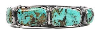A Navajo Silver and Turquoise Bracelet Length 5 x opening 1 5/8 x width 3/4 inches.