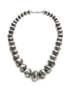A Navajo Silver Bead Necklace Length 19 inches, diameter of largest bead 1 inch.