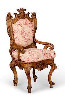 An imposing Italian Rococo carved walnut armchair