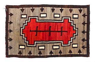 A Navajo Ganado Rug Largest: 74 x 48 inches.