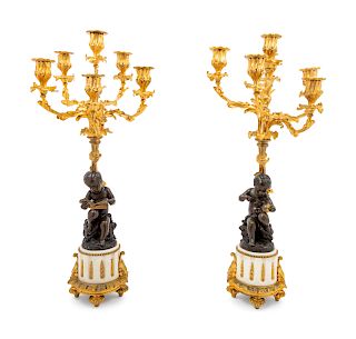 A Pair of Louis XVI Style Gilt and Patinated Bronze Figural Seven-Light Candelabra