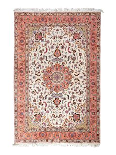 A Tabriz Wool Rug
9 feet 8 inches x 6 feet 7 1/4 inches. 