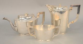 Three piece silver tea set, to include teapot, two handled sugar bowl and a coffee pot, each of oval shape with monogram. teapot height 7 inches. 46.8