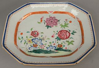 A Chinese export Famille Rose oblong octagonal platter, interior with a lush scene of blooming chrysanthemum, peony and other flowers between concentr