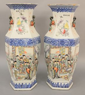 Pair of Chinese Famille Rose six sided vases, having painted panels, molded fruit and vine handles. heights 22 1/2 inches. Provenance: Estate of Mark 