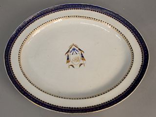 Chinese export oval tray, having blue and gilt border decorated with blue and gilded with a central drapery - mantled monogram. 13" x 16". Provences: 