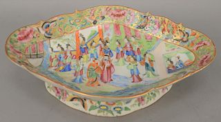 Famille Rose footed dish, having painted courtyard central scene with butterflies and flowers, 19th century. height 3 inches, top: 10 1/4" x 14 1/4". 