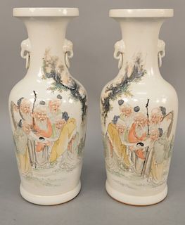 Pair of Chinese Famille Verte porcelain vases, painted with group of scholars observing a scroll with a ying yang symbol. height 16 1/2 inches.