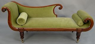 Empire mahogany settee, having a partial chaise lounge form with rolled arms on turned and fluted legs. length 80 inches, height 34 inches. Provenance