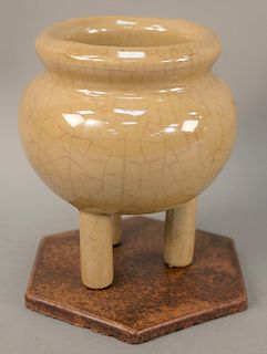 Crackle (ko/geyao) tripod censer, China 19th/20th century, of overall cafe au lait color, glued to thin wooden base, no mark, one leg repaired. height