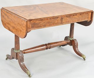 Federal mahogany drop leaf sofa table, having one drawer on either side, set on turned columns having gilt bronze mounts with turned stretcher, all on