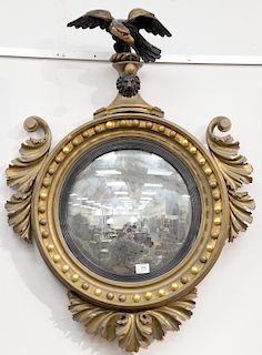 Federal convex mirror, having ebonized eagle crest and foliate carved sides with remanence of original gilt, 19th century. height 37 inches, width 28 