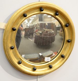 Regency diminutive gilt convex mirror, having circular gilt frame with black painted spheres. diameter 19 1/4 inches.