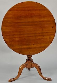 Cherry tip table with round top on birdcage, set on urn turned shaft set on tripod base. height 27 1/2 inches, top: 30 1/2" x 30 5/8".