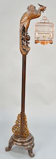 Chinese carved floor lamp stand, carved form peacock holding a birdcage. height 74 inches.