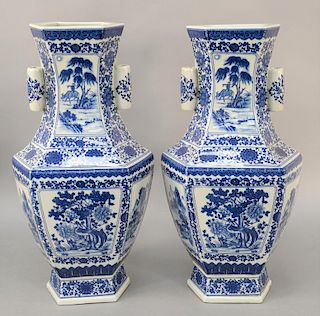 Large pair of blue & white hexagonal vases, China, 20th century, with applied tubular handles at their necks, with bird, floral, and landscape reserve