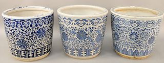 Set of three blue and white porcelain Chinese planters, having painted scrolly vines and flowers. height 3 3/4 inches, diameter 15 1/4 inches. Provena
