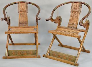 Pair of horseshoe folding/campaign armchairs, China 19th/20th century, possibly Huanghuali wood, with brass fittings, slatted seats and archaic dragon