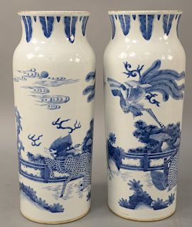 Pair of blue and white sleeve form porcelain vases, 19th century or older, landscape scene with flying phoenix on qilin. height 15 1/2 inches.