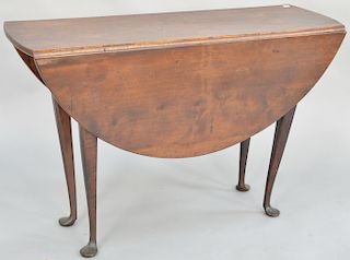 Queen Anne table, having round drop leaves on base with cabriole legs ending in pad feet. height 28 1/4 inches, top: 14" x 44", top open: 44" x 45 1/2