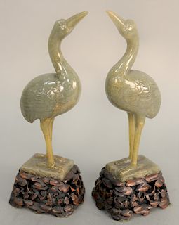 Pair of Chinese green gray jade cranes, having raised head and standing on square jade base mounted on carved wood elevated base, repaired legs. total