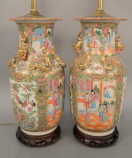 Pair of Rose Medallion vases, China, 19th century, of baluster shape with applied gilt foo dog handles and serpentine qilin, made into lamps. height 1