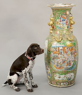 Rose Medallion palace size vase, having painted panels of courtyards with figures molded gilt dragons and gilt foo dog handles, minor chips to rim, pr