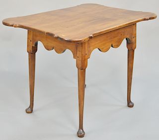 Queen Anne tea table, having porringer top, set on scalloped base set on turned legs ending in pad feet, circa 1750, top probably original but flipped