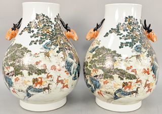 Large pair of Hu vases, China, decorated with applied deer handles and famille verte landscape scenes of a “thousand” deer and pine trees, base marked